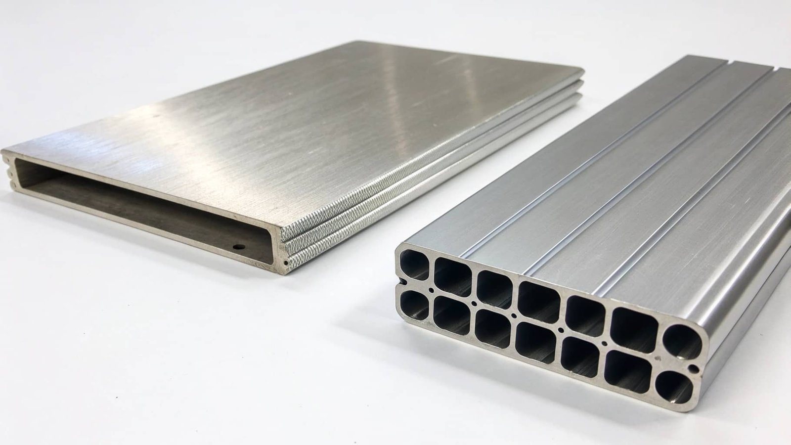 A scale showing one kilogram of steel on one side and three kilograms of 6061 aluminum on the other, balanced to show the volume difference.